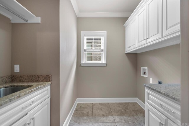 9 Bishop Pl, Little Rock, AR 72223 - washroom featuring hookup for a washing machine, crown molding, cabinet space, and light tile patterned floors