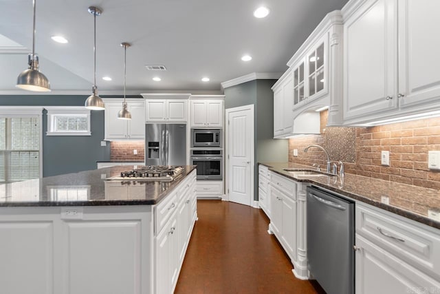 9 Bishop Pl, Little Rock, AR 72223 - kitchen featuring appliances with stainless steel finishes, a center island, white cabinetry, recessed lighting, and backsplash