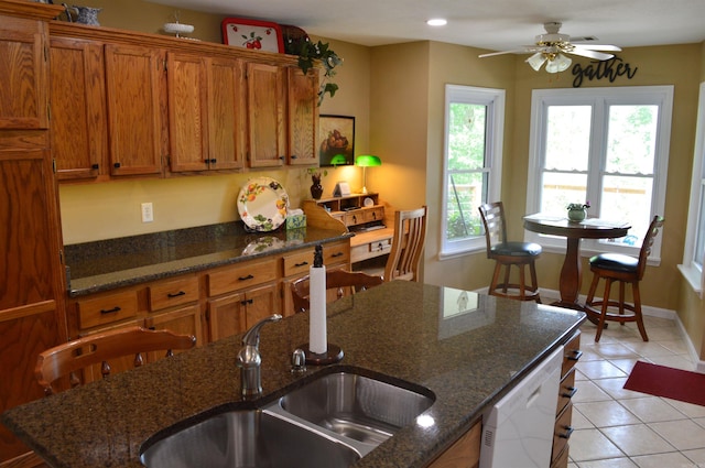 1005 Georgia Ridge Rd, Searcy, AR 72143 - kitchen featuring brown cabinets, healthy amount of natural light, white dishwasher, and light tile patterned floors