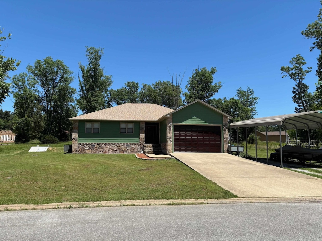 303 Whitewater Dr, Mountain View, AR 72560 - view of front of home with an attached garage, a front lawn, driveway, and stone siding