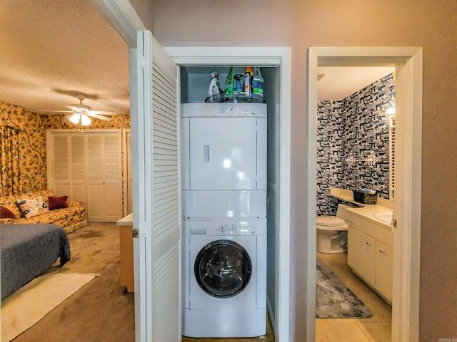 1127 Twin Points Rd Unit A, Hot Springs, AR 71913 - laundry area with stacked washer and clothes dryer, a ceiling fan, wallpapered walls, and light carpet