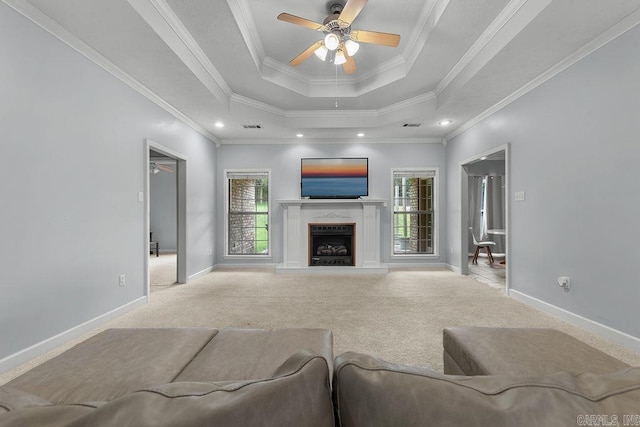 31 Auburn Hills Dr, Greenbrier, AR 72058 - carpeted living area with plenty of natural light, a tray ceiling, a ceiling fan, ornamental molding, and a fireplace with raised hearth