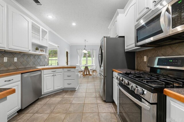 31 Auburn Hills Dr, Greenbrier, AR 72058 - kitchen featuring appliances with stainless steel finishes, ornamental molding, white cabinets, decorative backsplash, and recessed lighting