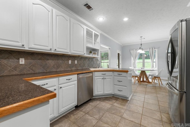 31 Auburn Hills Dr, Greenbrier, AR 72058 - kitchen with stainless steel appliances, crown molding, a peninsula, backsplash, and white cabinetry