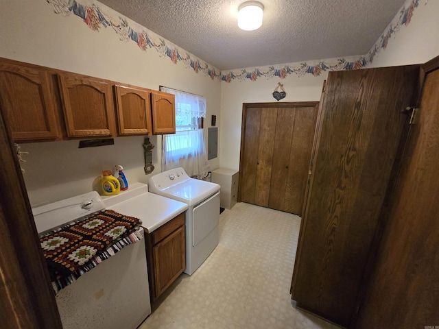 1206 Broadway Ave, Bull Shoals, AR 72619 - washroom featuring cabinet space, washing machine and clothes dryer, a textured ceiling, electric panel, and light floors