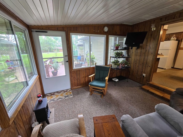 1206 Broadway Ave, Bull Shoals, AR 72619 - sunroom with wood walls, carpet, and vaulted ceiling