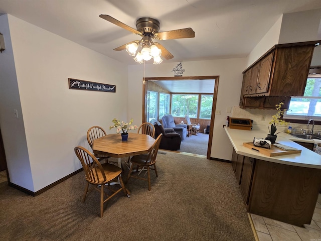 1206 Broadway Ave, Bull Shoals, AR 72619 - dining space featuring ceiling fan, plenty of natural light, and light colored carpet