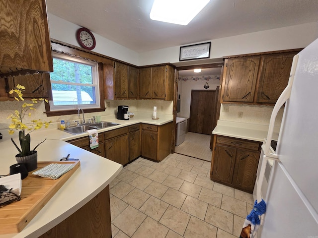 1206 Broadway Ave, Bull Shoals, AR 72619 - kitchen with freestanding refrigerator, light countertops, decorative backsplash, and light tile patterned floors