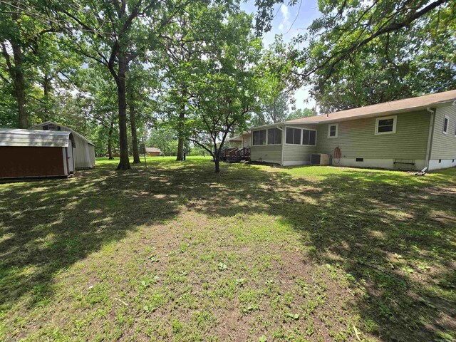 1206 Broadway Ave, Bull Shoals, AR 72619 - view of grassy yard featuring a storage shed and a sunroom