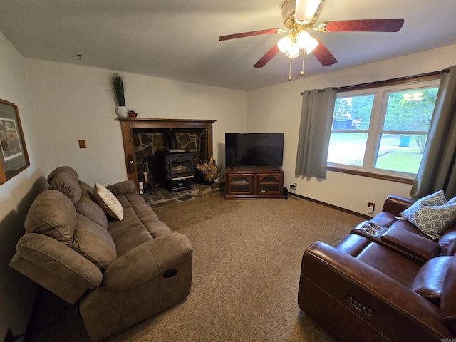 1206 Broadway Ave, Bull Shoals, AR 72619 - carpeted living room with a wood stove and ceiling fan