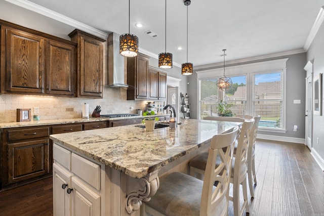 2705 Pulaski Dr, Conway, AR 72034 - kitchen with wall chimney exhaust hood, light stone countertops, tasteful backsplash, dark wood-style floors, and crown molding