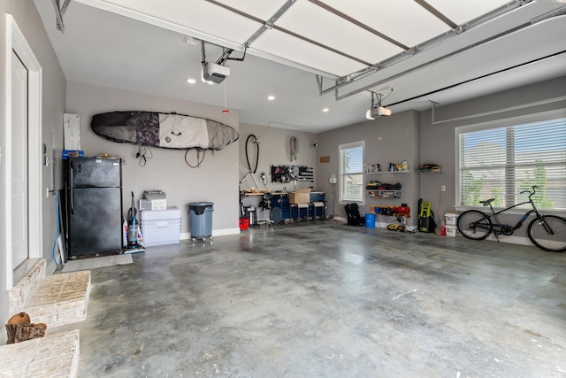2705 Pulaski Dr, Conway, AR 72034 - garage featuring freestanding refrigerator, a garage door opener, and recessed lighting