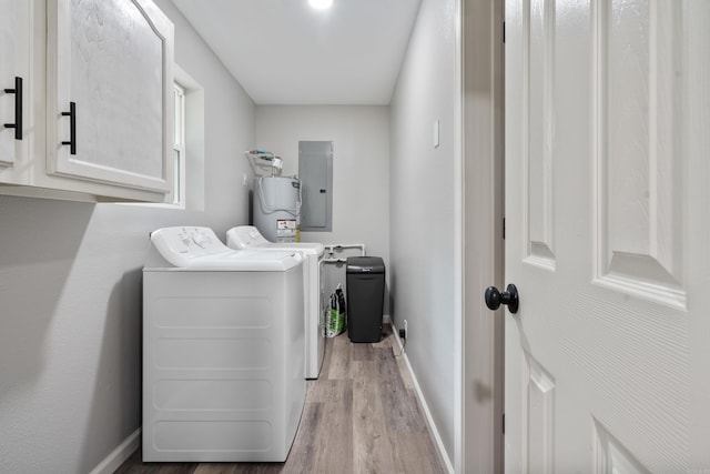 laundry area featuring cabinet space, electric panel, separate washer and dryer, wood finished floors, and water heater