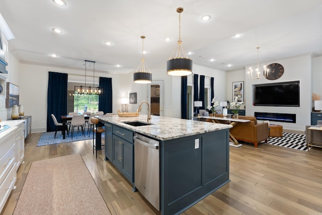 2960 Orchard View Dr, Conway, AR 72034 - kitchen with a chandelier, dishwasher, light wood-style floors, an island with sink, and light stone countertops