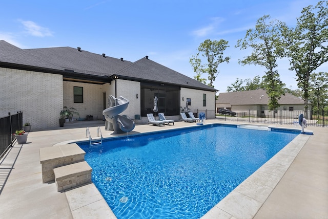2960 Orchard View Dr, Conway, AR 72034 - view of swimming pool with a water slide, a patio, and a sunroom