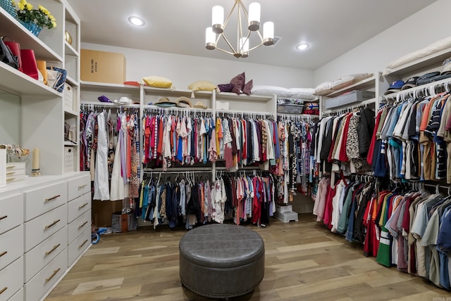 2960 Orchard View Dr, Conway, AR 72034 - walk in closet featuring wood finished floors and a chandelier