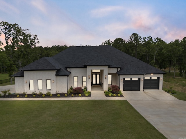 2960 Orchard View Dr, Conway, AR 72034 - view of front of property featuring french doors, concrete driveway, a lawn, and a garage