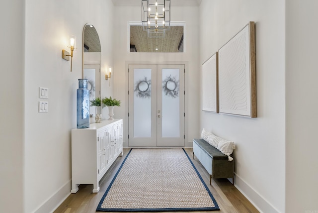 2960 Orchard View Dr, Conway, AR 72034 - entrance foyer with light wood-type flooring, french doors, and a chandelier