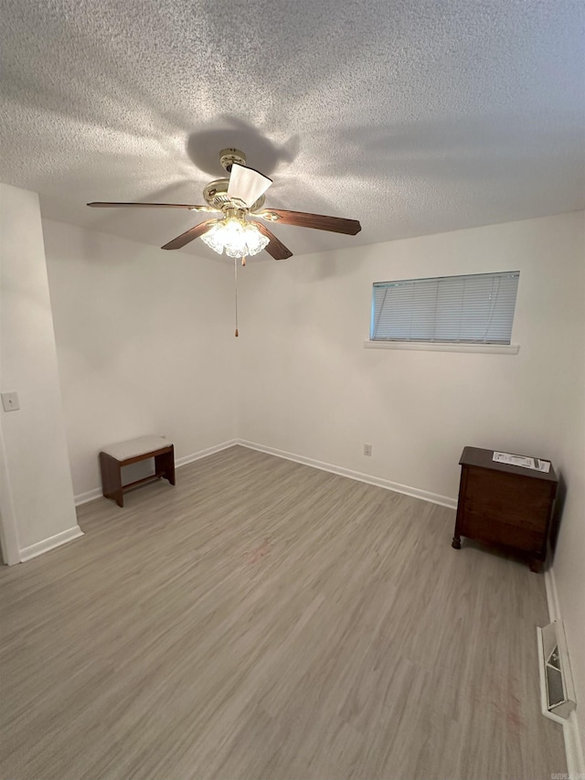 900 Davidson Cir, Edgemont, AR 72044 - unfurnished room featuring a ceiling fan, wood finished floors, and a textured ceiling