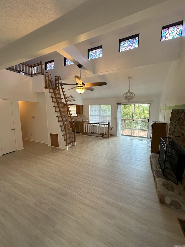900 Davidson Cir, Edgemont, AR 72044 - living area featuring a high ceiling, light wood-style floors, a chandelier, stairs, and a fireplace