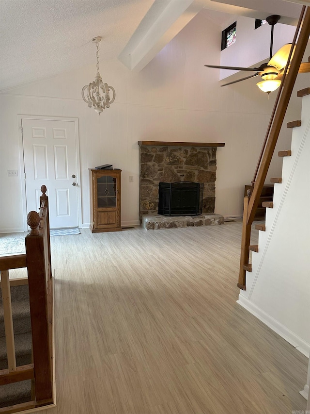 900 Davidson Cir, Edgemont, AR 72044 - unfurnished living room featuring lofted ceiling, stairs, wood finished floors, a fireplace, and ceiling fan