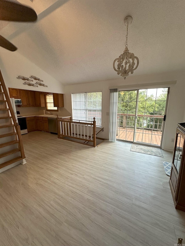 900 Davidson Cir, Edgemont, AR 72044 - living area featuring a textured ceiling, a chandelier, vaulted ceiling, light wood-type flooring, and stairs