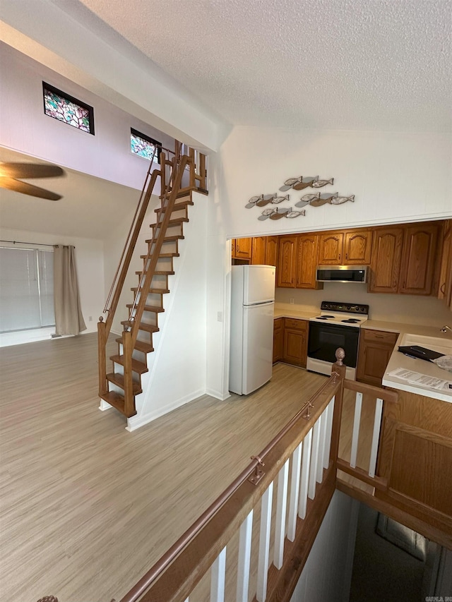 900 Davidson Cir, Edgemont, AR 72044 - kitchen featuring white appliances, ventilation hood, a textured ceiling, brown cabinets, and light countertops