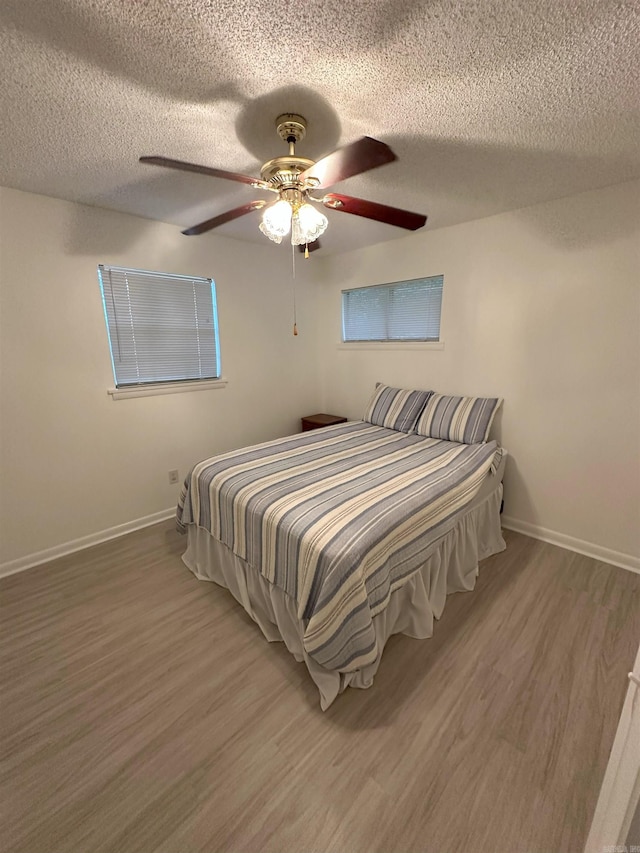 900 Davidson Cir, Edgemont, AR 72044 - bedroom with a textured ceiling, wood finished floors, and a ceiling fan