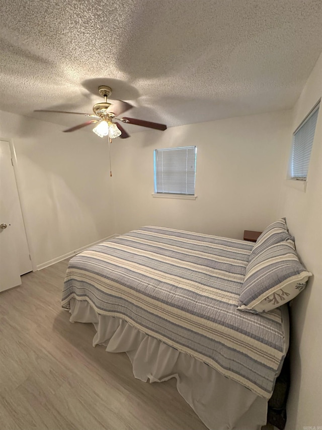 900 Davidson Cir, Edgemont, AR 72044 - bedroom featuring wood finished floors, a textured ceiling, and ceiling fan