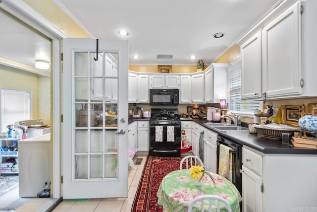 7111 W Markham St, Little Rock, AR 72205 - kitchen featuring black appliances, dark countertops, light tile patterned flooring, and white cabinetry
