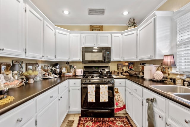 7111 W Markham St, Little Rock, AR 72205 - kitchen featuring black appliances, white cabinets, and recessed lighting