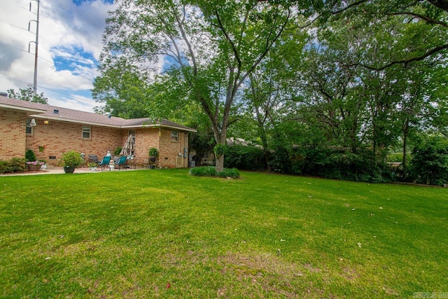 7111 W Markham St, Little Rock, AR 72205 - view of green lawn with a patio