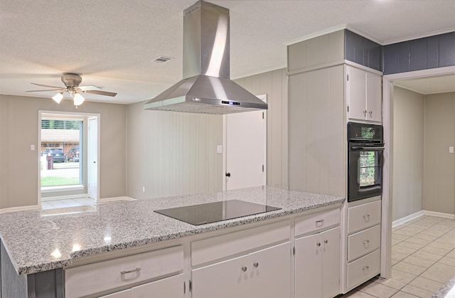 6905 White Oak Cv, White Hall, AR 71602 - kitchen featuring black appliances, island exhaust hood, ceiling fan, light tile patterned floors, and white cabinetry