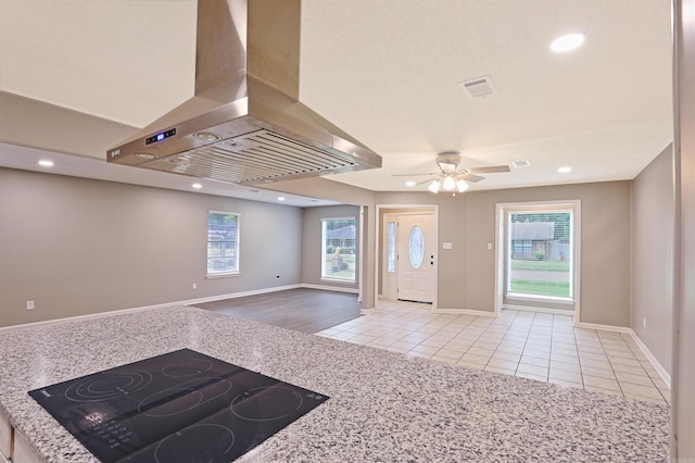 6905 White Oak Cv, White Hall, AR 71602 - kitchen with exhaust hood, black electric stovetop, light tile patterned flooring, plenty of natural light, and recessed lighting