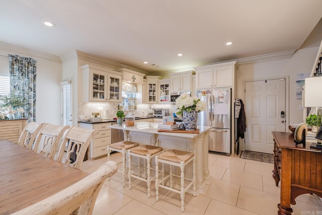 410A Halteria, Hot Springs, AR 71913 - kitchen with stainless steel appliances, crown molding, a kitchen island, tasteful backsplash, and healthy amount of natural light