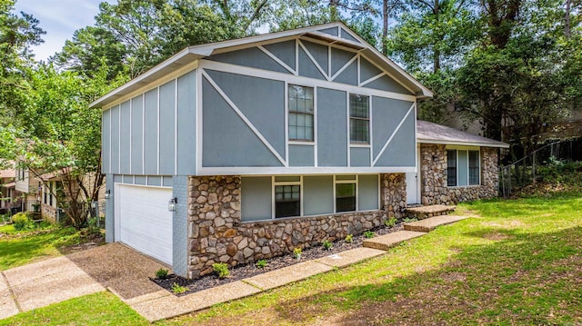 4901 Westwood Ave, Little Rock, AR 72204 - view of front of house with stone siding, driveway, a garage, board and batten siding, and a front lawn