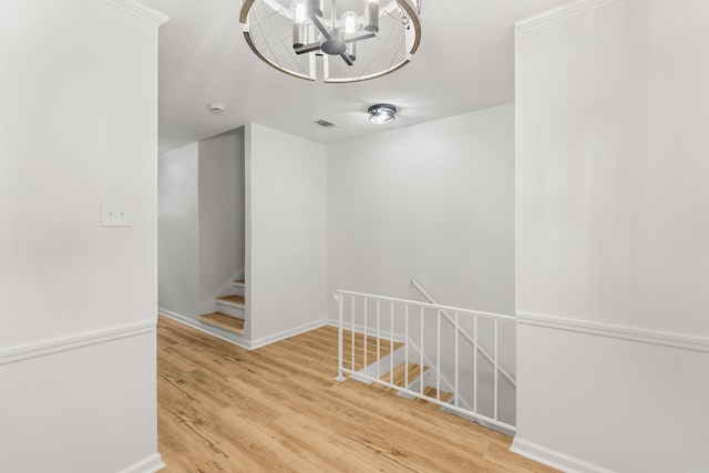 4901 Westwood Ave, Little Rock, AR 72204 - stairway with wood finished floors and a chandelier