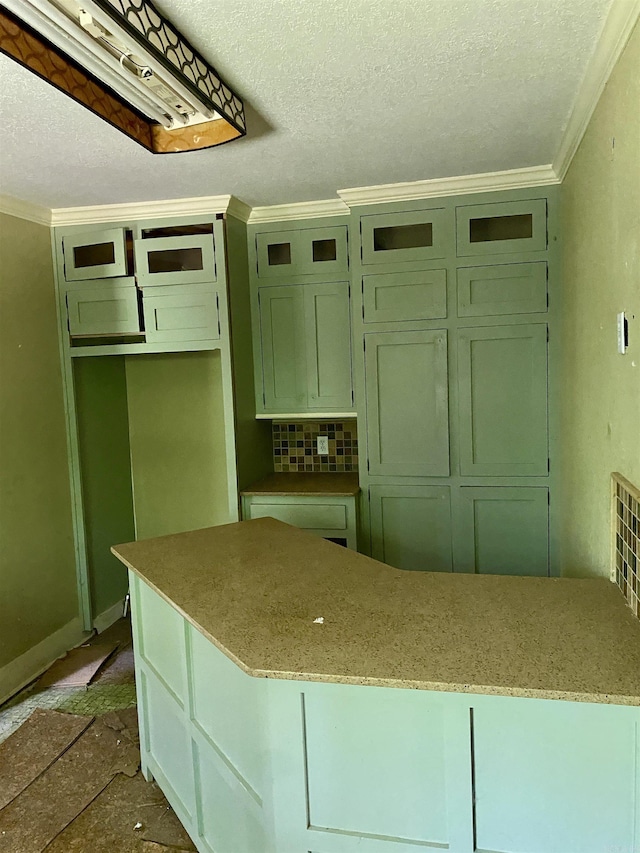 2767 E Main St, Lamar, AR 72846 - kitchen with ornamental molding, a textured ceiling, light stone counters, decorative backsplash, and green cabinets