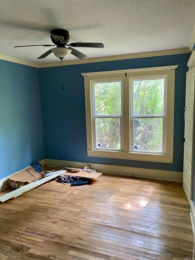 2767 E Main St, Lamar, AR 72846 - spare room featuring plenty of natural light, crown molding, hardwood / wood-style floors, a textured ceiling, and a ceiling fan