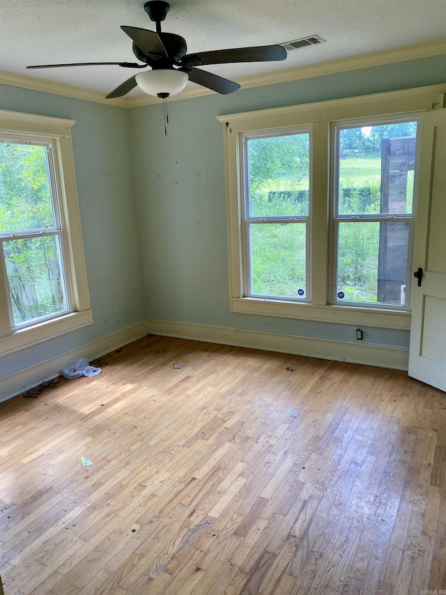 2767 E Main St, Lamar, AR 72846 - unfurnished room featuring light wood-style floors, plenty of natural light, crown molding, and a ceiling fan
