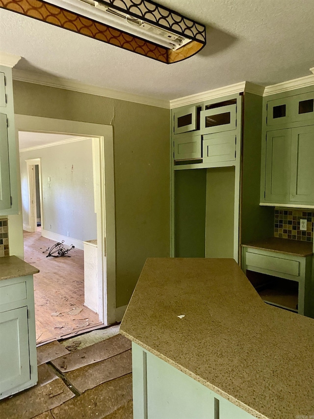 2767 E Main St, Lamar, AR 72846 - kitchen featuring green cabinetry, ornamental molding, backsplash, and a textured ceiling