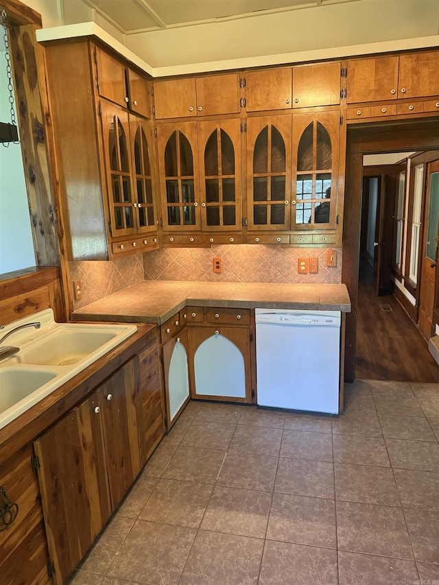 408 Case St, Heber Springs, AR 72543 - kitchen featuring dishwasher, brown cabinets, backsplash, and glass insert cabinets