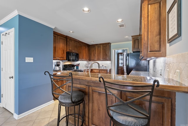 144 Summit Valley Cir, Maumelle, AR 72113 - kitchen featuring black appliances, a kitchen bar, crown molding, tasteful backsplash, and light tile patterned floors