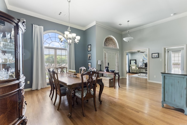 144 Summit Valley Cir, Maumelle, AR 72113 - dining area featuring healthy amount of natural light, light wood-style flooring, ornamental molding, ceiling fan, and a chandelier