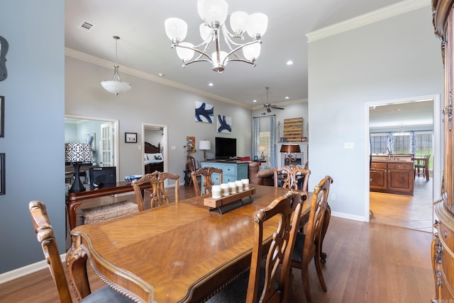 144 Summit Valley Cir, Maumelle, AR 72113 - dining room featuring a chandelier, wood finished floors, crown molding, and recessed lighting