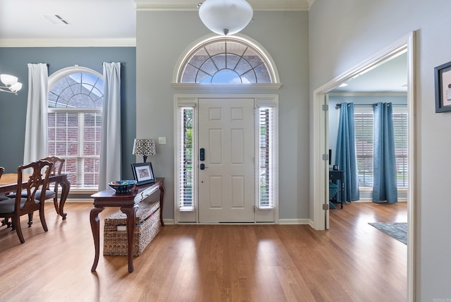 144 Summit Valley Cir, Maumelle, AR 72113 - entrance foyer with wood finished floors, plenty of natural light, and ornamental molding