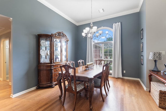 144 Summit Valley Cir, Maumelle, AR 72113 - dining space featuring light wood-type flooring, crown molding, and a chandelier