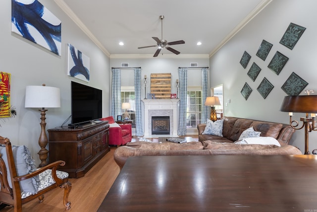 144 Summit Valley Cir, Maumelle, AR 72113 - living area featuring ceiling fan, crown molding, light wood-style flooring, a fireplace, and recessed lighting