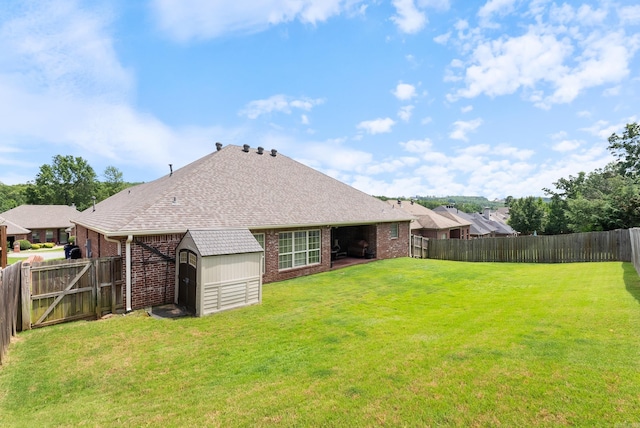 144 Summit Valley Cir, Maumelle, AR 72113 - back of property with brick siding, a storage unit, a fenced backyard, and a shingled roof