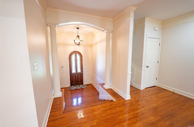 22 Jacob Pl, Little Rock, AR 72211 - foyer featuring wood finished floors, decorative columns, crown molding, and arched walkways